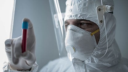 Medical technician wearing full-body protective gown